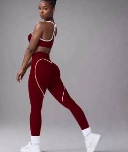 Detail of dark red yoga set showing white heart-shaped seams on leggings and sports bra