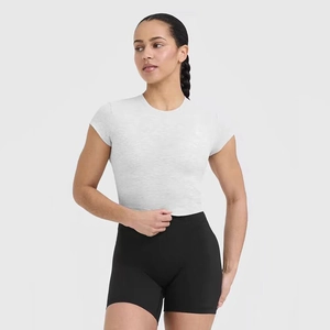 Close-up of white marl crop top and high-waisted black yoga shorts for fitness training