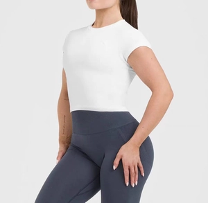 Side view of slim-fit white short-sleeve crop top paired with high-waist yoga leggings