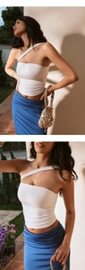 Detail view of white one-shoulder cropped yoga top with elegant side ruching and pleats