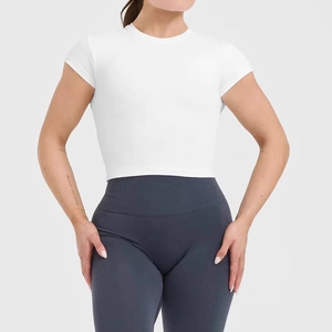 Detail of high-stretch white cropped sports tee and charcoal high-waist yoga leggings