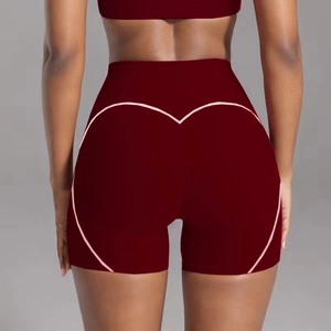 Detail of high waist yoga shorts with pink heart contour stitching for push-up effect