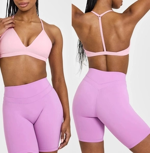Detailed view of pink V-neck sports bra and lilac high waist yoga shorts set