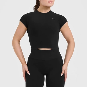 Close-up of black high-elasticity yoga crop top featuring a silver V-shaped logo on chest