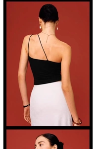 Close-up of the asymmetrical backless design of this sleek black sports yoga vest