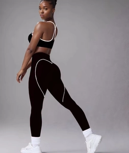 Detail view of black yoga set with white contrast piping for butt-lifting effect