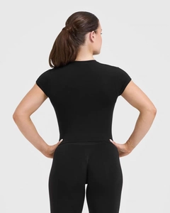 Slim fit black yoga t-shirt showing elastic back design and athletic seam details