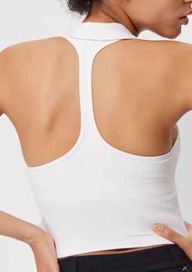 Detailed back view of a white racerback yoga vest with a stylish polo collar design