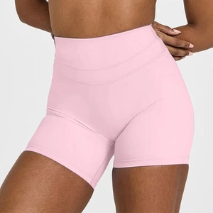 Close-up of pale pink high-waisted yoga shorts showing stretch fabric and reinforced stitching