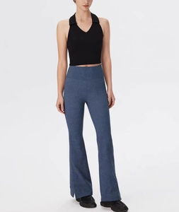 Detail view of high-elastic flare pants with split cuffs and soft ribbed fabric texture