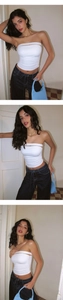 Detail of white halter neck yoga top with front cutout design paired with denim jeans