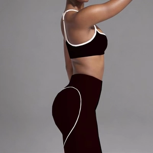 Detail of high-stretch yoga set featuring white piping and heart-shaped peach hip contour