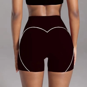 Rear view detail of black high-waist yoga shorts with white heart-shaped peach butt stitching