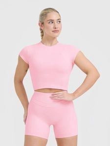 Pink slim fit yoga set featuring short sleeve crop top and high waist sports shorts