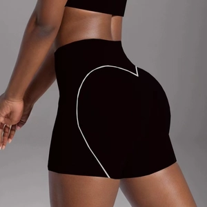 Close-up of black high-waist yoga shorts featuring white heart outline on the back