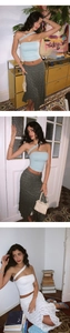 Detail shot of a light blue one-shoulder yoga top paired with a grey textured maxi skirt