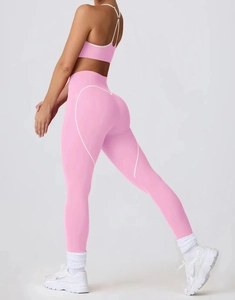 Detail of pink yoga leggings showing white heart-shaped lifting lines and peach butt effect