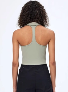 Rear view of light green polo yoga vest featuring an open back racerback design and collar