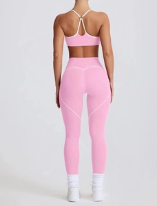 Detail view of pink high-waist yoga leggings with white heart-shaped lifting contours