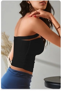 Detail of black yoga tank top featuring side ruching and chic cutout neckline design