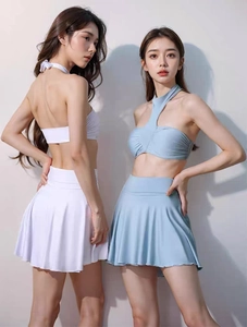 Detailed view of the two-piece halter neck swimwear with a pleated high-waisted skirt