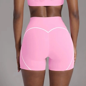 Detail of high-waist peach lift yoga shorts with white heart-shaped contour lines