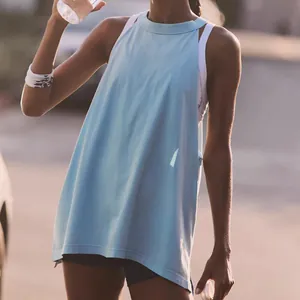 Detail of light blue loose yoga top with side cutouts and a layered back design