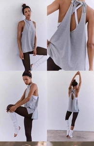 Detail view of light grey open back yoga top with elegant bow tie and loose fit design