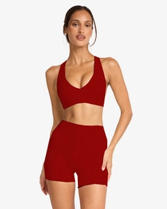 Macro detail of seamless dark red yoga set showing high-waist shorts and V-neck sports bra