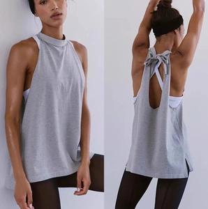 Women's loose grey yoga top featuring a stylish open back design with a delicate bow tie