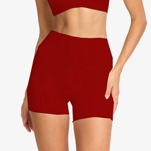 Detail of high-waisted burgundy yoga shorts and sports top with a snug, athletic fit