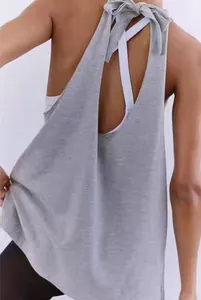 Detail of grey open back yoga top with chic tie-knot bow and breathable hollow design