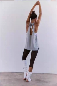 Detail of grey backless yoga top with an elegant bow tie design on the open back area