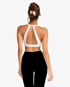 Detailed rear view of yoga sports bra with teardrop cutout and black fitness shorts