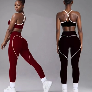 Women's yoga set with sports bra and leggings featuring heart-shaped contrast piping