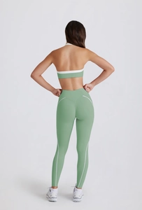 Back view of sage green yoga set with white contrast trim on high waist leggings