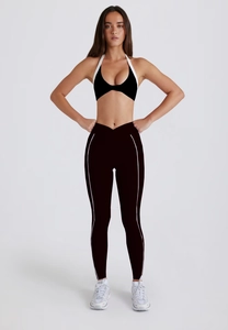 Detail view of two-piece yoga set with halter sports bra and high-waisted v-cut leggings