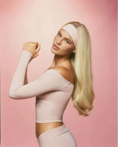 Close-up of light pink yoga top featuring off-shoulder design and built-in pads
