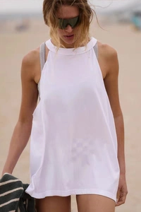 Detail of white backless yoga cover-up top featuring lightweight translucent fabric