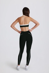 Back view of two-piece yoga set with color-block bra and streamlined fitness leggings