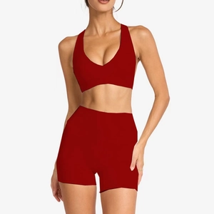 Two-piece deep red yoga set featuring a V-neck sports bra and high-waisted shorts
