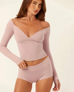 Close-up of off-shoulder v-neck yoga top and matching shorts in dusty rose fabric