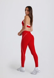 Detail of red and white high-waist yoga leggings and racerback sports bra set
