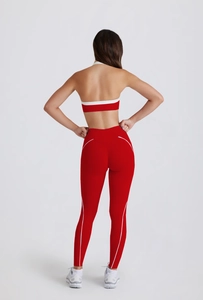 Rear view of red yoga set featuring halter back sports bra and high-waist leggings with white stripes