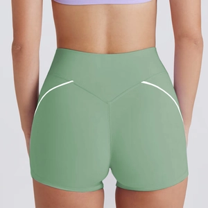 Detail view of high-waist light green yoga shorts with V-seam and white side stripes