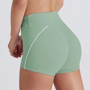 Detail of high-waist sage green yoga shorts with white side stripe and lifting seam