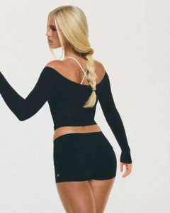 Detailed view of black yoga set featuring off-shoulder top with cross-back strap design