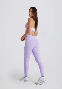 Detail of light purple yoga set with white side stripes and halter neck sports bra