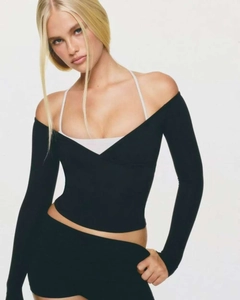 Detail of slim fit off-shoulder yoga top with layered white halter neck strap