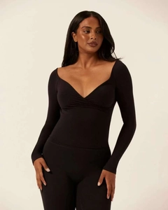 Close-up of black criss-cross V-neck yoga top with high-stretch athletic fabric texture